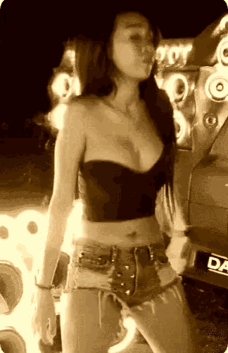 a woman is standing in front of a car with a license plate that says d