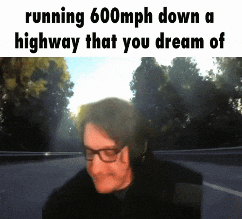a man wearing glasses is running 600mph down a highway