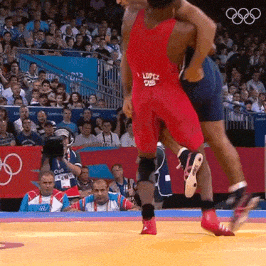 a wrestler with the name lopez on the back of his red singlet