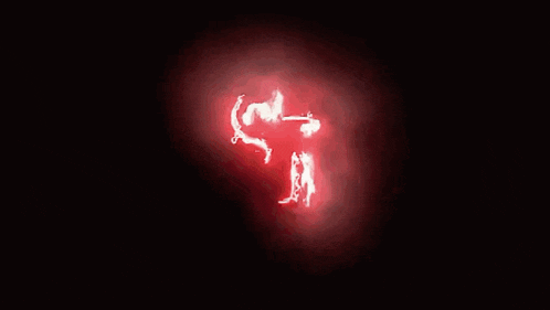 a person 's face is glowing red in the dark