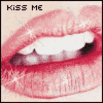 a close up of a woman 's lips with the words `` kiss me '' written in the corner .