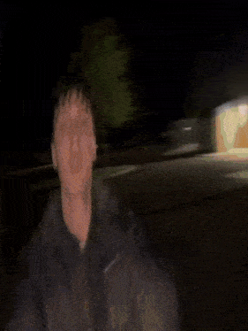 a blurry picture of a man 's face in the dark .