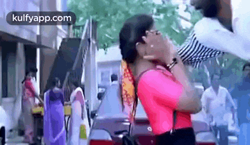 a man is holding a woman in his arms in a crowded street .