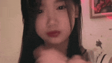 a close up of a woman 's face with red lipstick on .