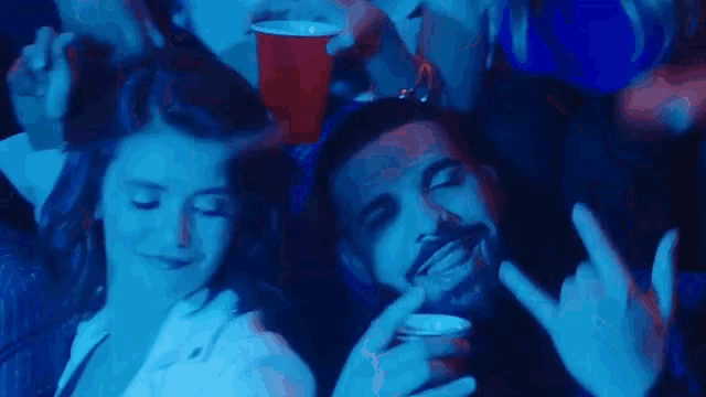 a man and a woman are sitting next to each other in a dark room .