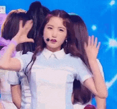 a woman in a blue and white shirt with a microphone on her head