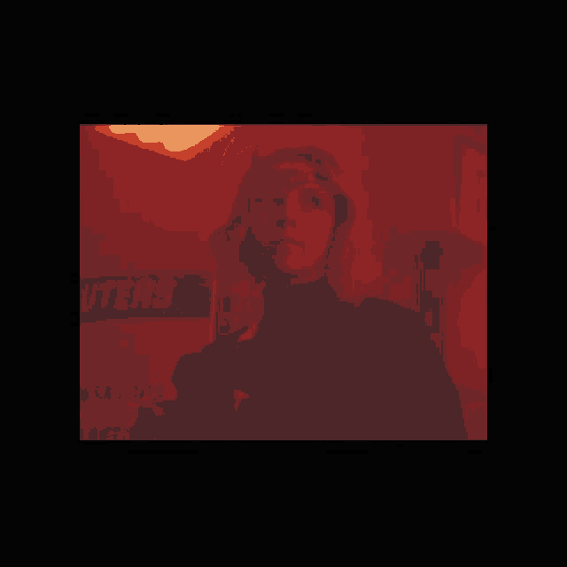 a woman in a red room with a sign that says ' outer ' on it