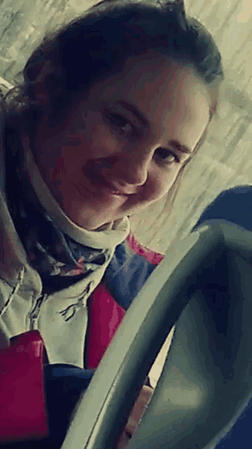 a woman with a scarf around her neck has the letter s on it