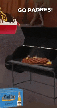 a box of medalla is next to a grill with a steak on it