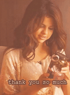 a woman is smiling and holding a gift with the words thank you so much written below her
