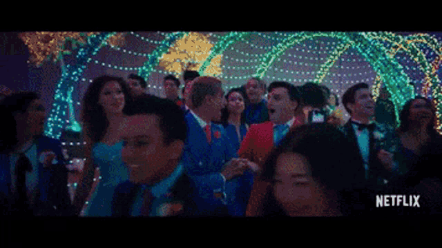 a group of people dancing in front of a netflix sign
