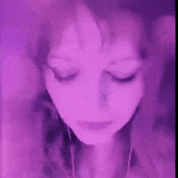 a close up of a woman 's face with a purple background .