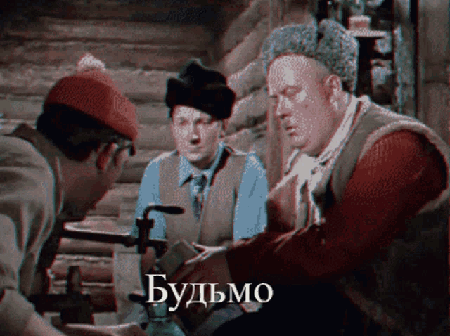 a group of men are sitting around a table with the word budymo on the bottom right
