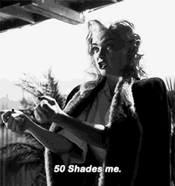 a woman in a fur coat is smoking a cigarette and saying `` 50 shades me '' .