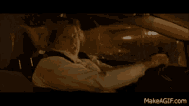 a man in a white shirt and tie is driving a car