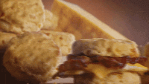 a close up of a sandwich with cheese and bacon
