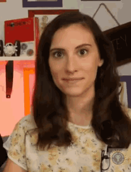 a woman is standing in front of a shelf with a book called mother ii on it
