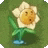 a yellow and white flower with a face on it is growing out of the ground .