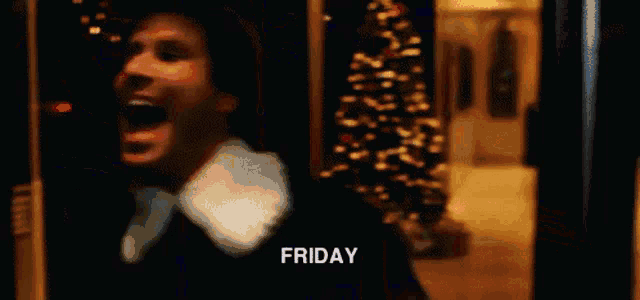 a close up of a man 's face with his mouth open and the words `` friday '' written on it .