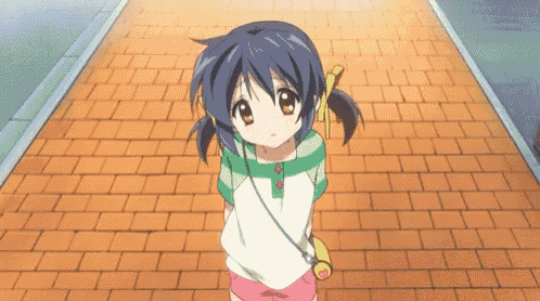 a little girl with blue hair is standing on a brick walkway