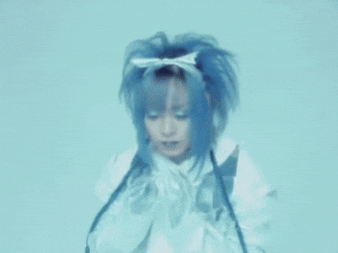 a woman with blue hair and a white bow on her head