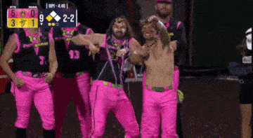 a group of people wearing pink pants are dancing in front of a scoreboard that says mp1 4.40
