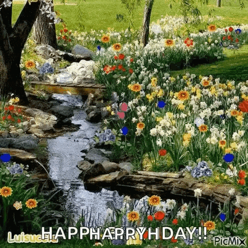 a stream runs through a garden filled with lots of flowers and trees .