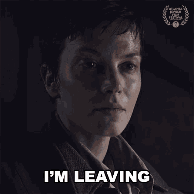 a woman says " i 'm leaving " in front of a laurel wreath