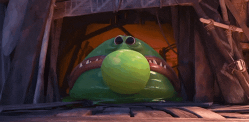 a green frog with big eyes and sharp teeth looks at the camera