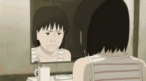 a girl is looking at herself in a mirror with a toothpaste in a cup
