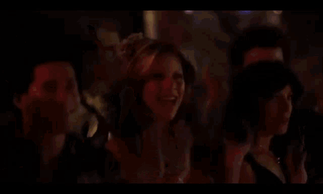 a man is dancing on a disco floor in front of a crowd of people .