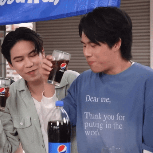 a man in a blue shirt that says dear me