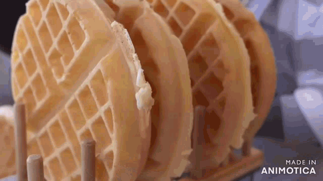 a stack of waffles sitting on top of each other on a wooden rack .