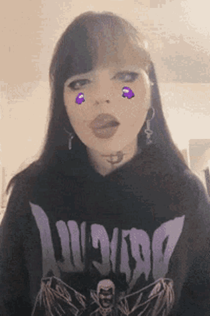 a girl wearing a black shirt that says doom is making a funny face