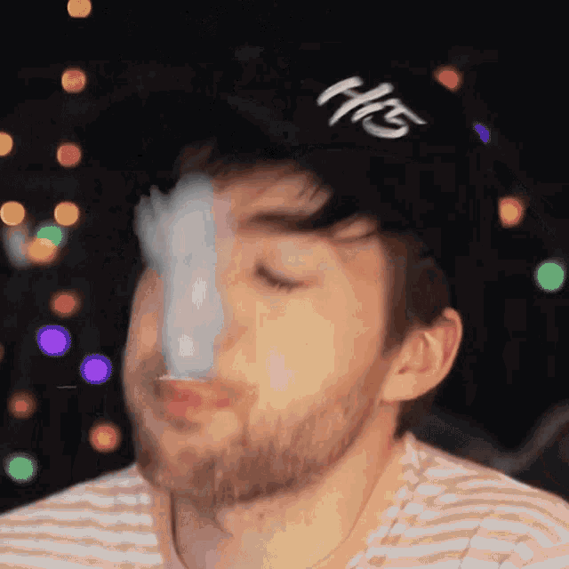 a man with a beard wearing a hat that says his on it