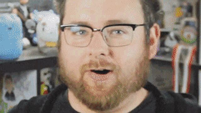 a man with glasses and a beard has his mouth open