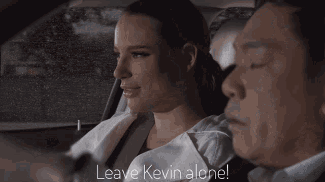 a man and a woman in a car with leave kevin alone written on the screen