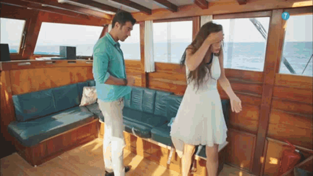 a man and woman on a boat with the number 7 on the bottom