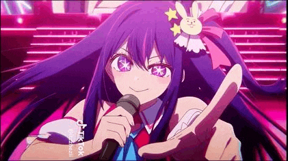 a girl with long purple hair is holding a microphone in her hand .