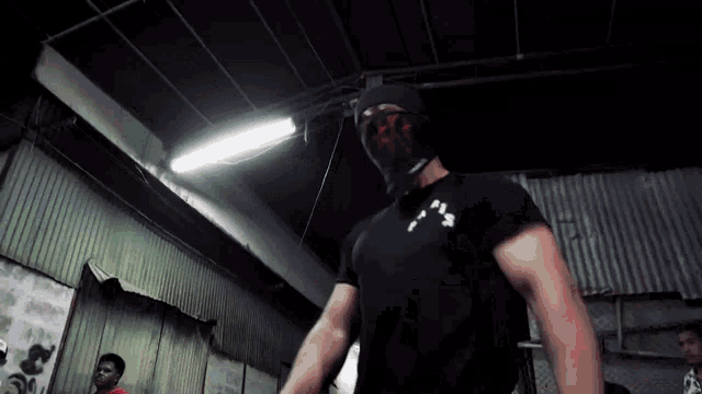 a man wearing a mask and a t-shirt that says pss