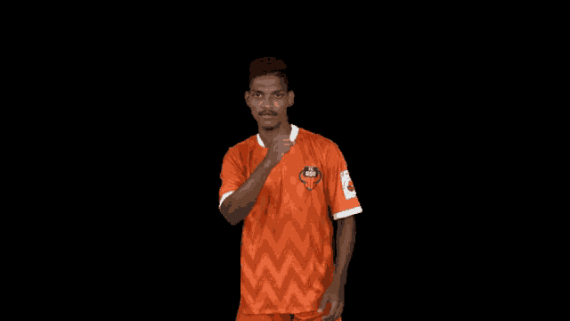 a man wearing an orange shirt that says uae on it