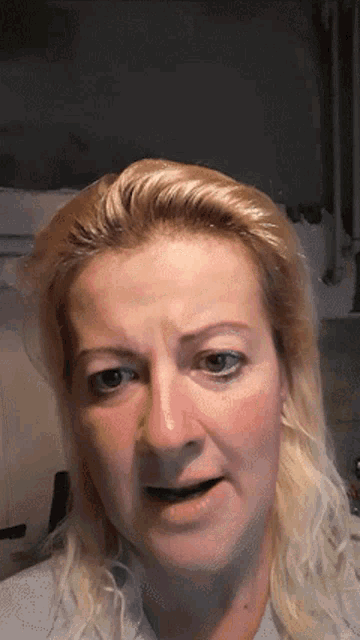 a close up of a woman 's face with a tear coming out of her nose