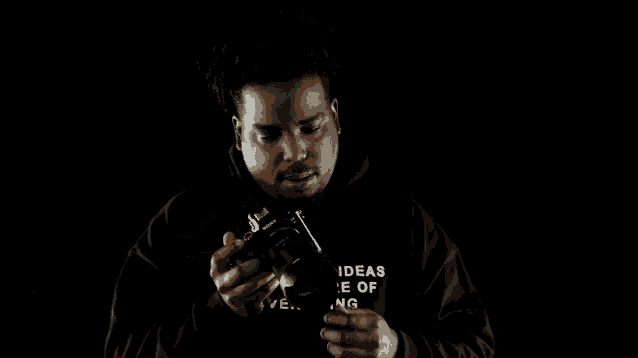 a man in a black hoodie that says ' dreams with ideas is the future of advertising ' on it
