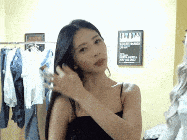 a woman adjusts her hair in front of a celeste barber sign