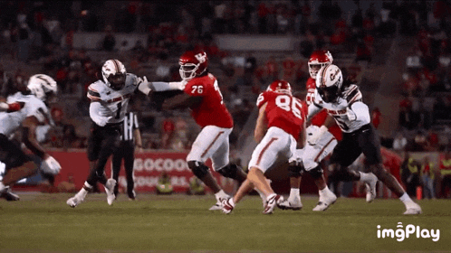 a football game is being played with the number 76 on the back of the jersey