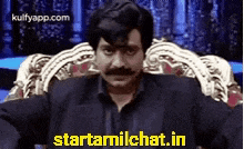 a man with a mustache is sitting in a chair with his arms outstretched and the words startamilchat.in below him