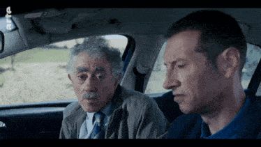 two men are sitting in a car with the word rtl on the bottom of the screen