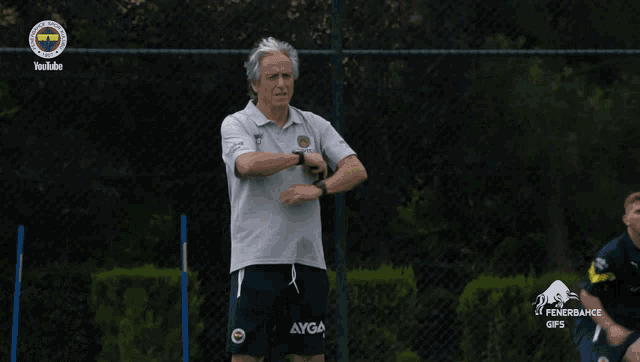 a man wearing a beko shirt stands on a soccer field
