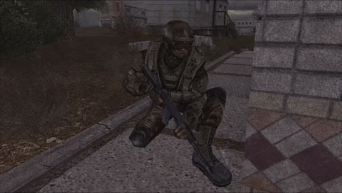a soldier in a video game is kneeling down holding a gun