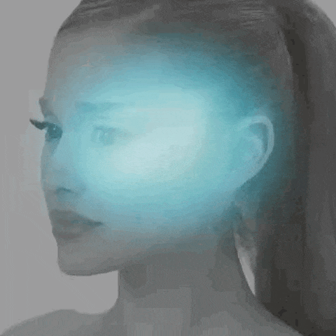 a close up of a woman 's face with a blue light coming out of her head .